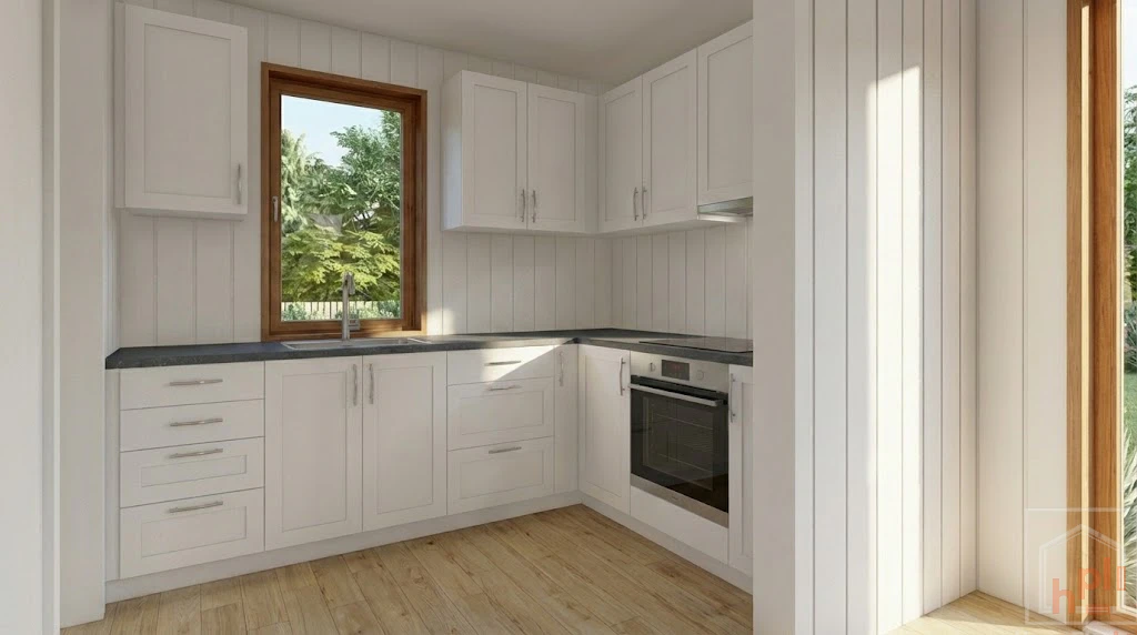 Photorealistic render of the L-shaped tiny house kitchen with white cabinets, dark countertops, and a window above the sink.
