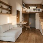 Beautiful modern tiny house interior with multifunctional furniture, loft bedroom, hidden storage, minimalist style, warm natural lighting